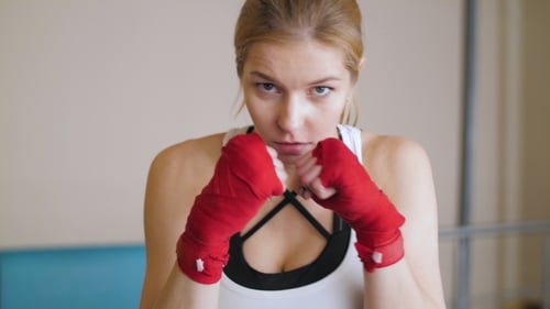 The Energetic Woman In The Gym Boxing. A Look At The Enemy. A Looking At The Camera