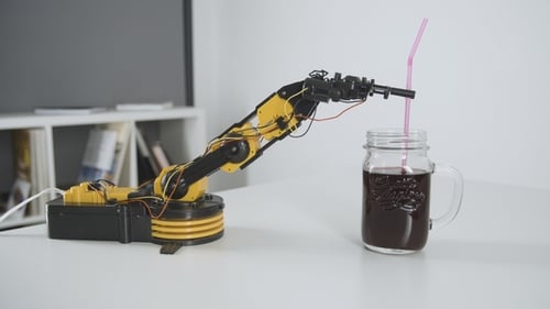 Robotic Arm Places Straw Into Glass of Drink