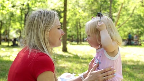 Woman with Child in the Park Outdoors