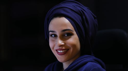 Young Woman Smiling Wearing Navy Head Covering