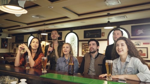 Friends Football Fans Are Cheering on in Sports Bar Watching Important Match and Having Fun in the