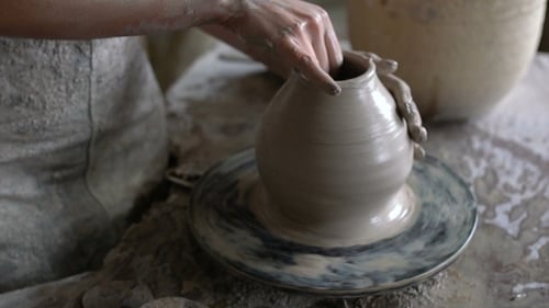 Hands Shaping Clay on Pottery Wheel