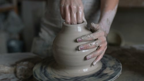 Hands Shaping Clay Pot on Pottery Wheel