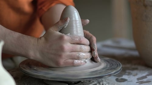 Potter Shaping Clay on Pottery Wheel Close Up