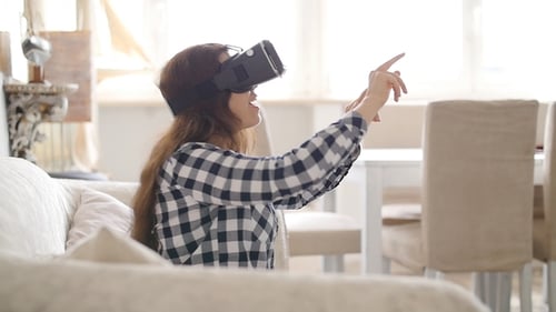 Woman Experiencing Virtual Reality Headset at Home