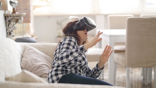 Woman Experiencing Virtual Reality at Home