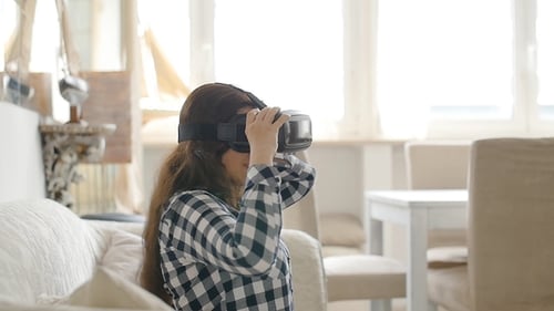 Woman Experiencing Virtual Reality in a Bright Living Room