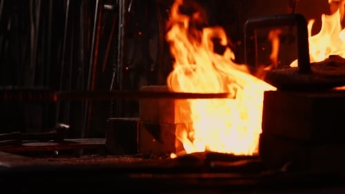 Intense Fire Flames in Dark Industrial Setting