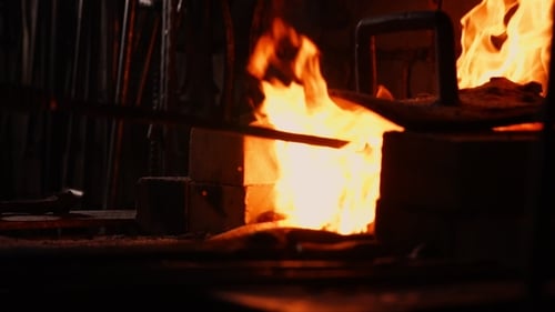 Intense Flames Burning Inside Dark Metalworking Forge