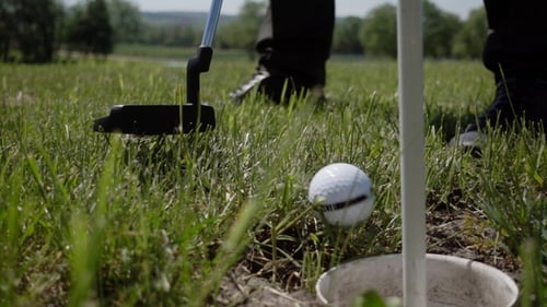 Golf Ball on the Green Close To the Hole