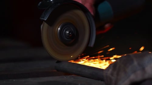 Sparks Fly While Cutting Metal Rod