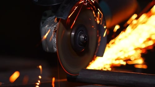 Abrasive Saw Cuts Through Metal With Sparks