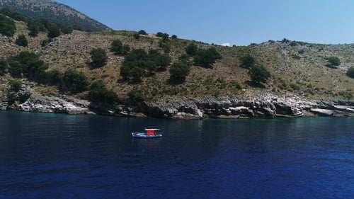 View of the Small Boat with Mountain Seaside in Background