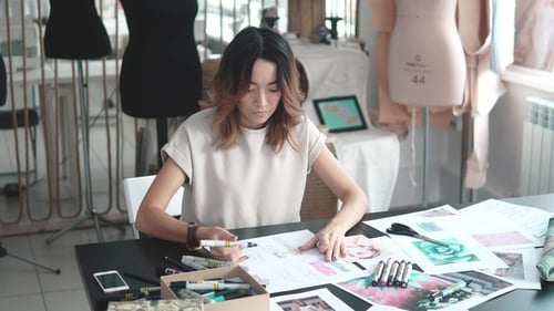 Designer Draw Sketches in the Studio. Workspace Designer. Fashion Designer Works in the Atelier