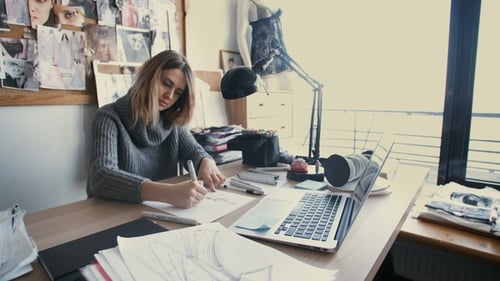 Beautiful Designer Drawing Sketches in the Studio