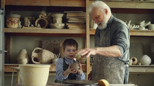 Man and Child Make Pottery Together