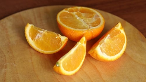 Sliced Ripe Oranges on a Wooden Chopping Board.