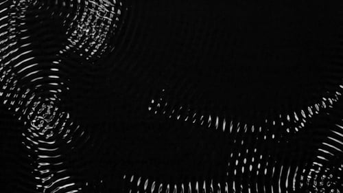 Levels of Sound Frequencies Draw Shapes on the Water. Black Background.