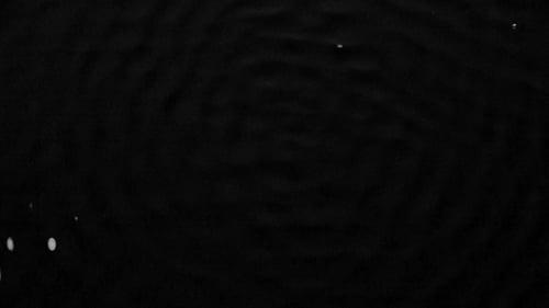 Graphic Image of Vibration of the Subwoofer on the Water Surface. Black Background.