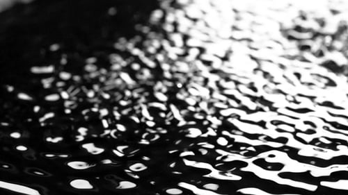 Light and Bubbling Water Under the Influence of Ultrasound. Black Background.