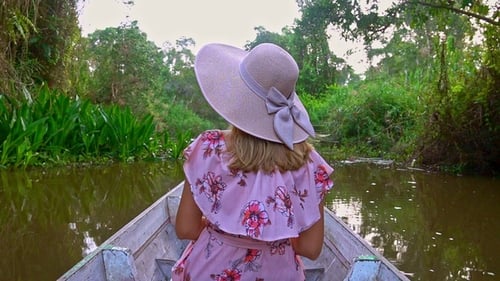 Female Tourist in Hat Riding Boat. Young Woman Visiting Thale Noi Waterfowl Reserve Lake, Thailand