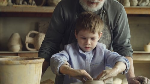 Child Makes Pottery with Senior Guidance