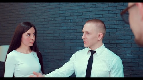 Three Professionals Discuss Business in Modern Office