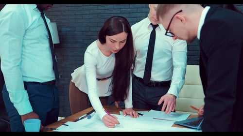 Business People Working Together on a Document During a Meeting in an Office