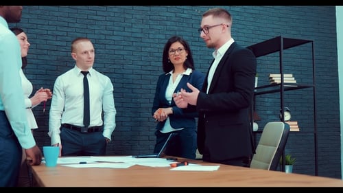 Group of Six Designers Discussing Architectural Complex While Working in Office