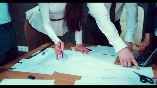 Business People Architects Working Together on a Document During a Meeting at the Office