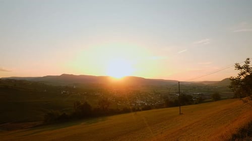 Golden Sunrise over Rural Landscape and Town