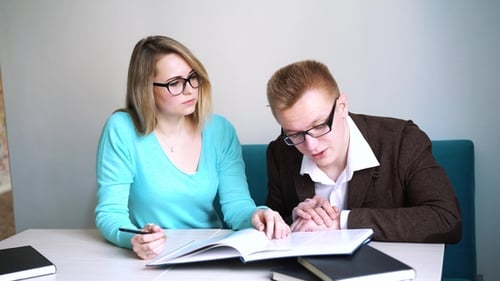 Male and Female Students Doing Homework Together Spending Time in Campus