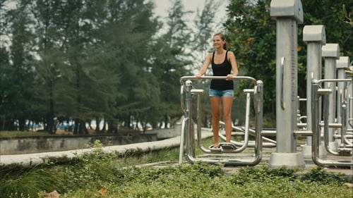 Woman Exercising on Outdoor Fitness Equipment