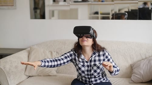 Woman Experiencing Virtual Reality Headset on Couch