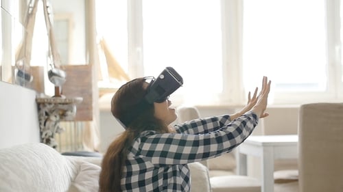 Woman Experiencing Virtual Reality at Home