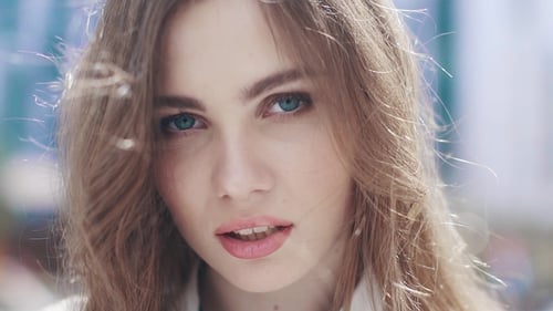 Portrait of a Young Pretty Girl in a City in the Light