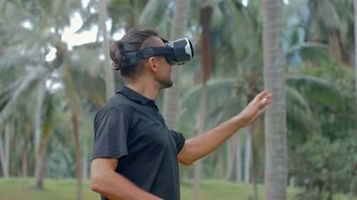 Mann nutzt Virtual-Reality-Headset im Dschungel