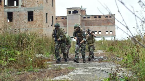 Soldiers Walk Through an Abandoned Urban Area