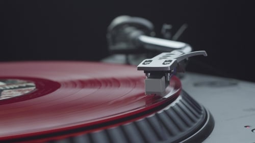 Red Vinyl Record Spins on Turntable Close Up