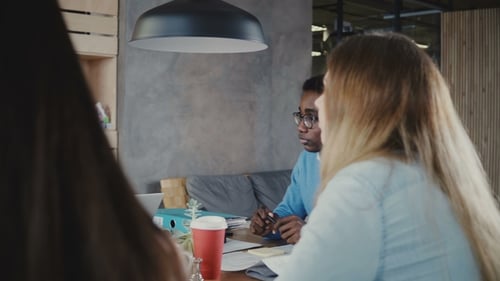 Panning Shot of Happy Multiethnic People Collaborating in Modern Trendy Office. Business Partners