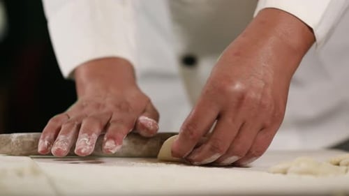 Chef Rolling Dough with a Rolling Pin