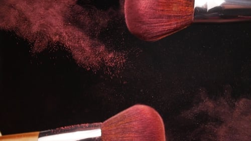 Make-up Brush with Pink Powder on Black Background