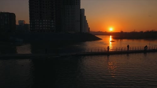 Aerial View Shot Silhouette of People Fishing Standing on the Bridge on the Yenisei River at Sunset