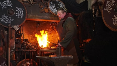 Blacksmith Forging Metal in a Fiery Historical Workshop