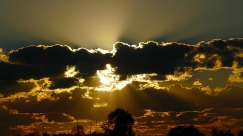 Golden Sunbeams Through Dark Clouds in the Sky