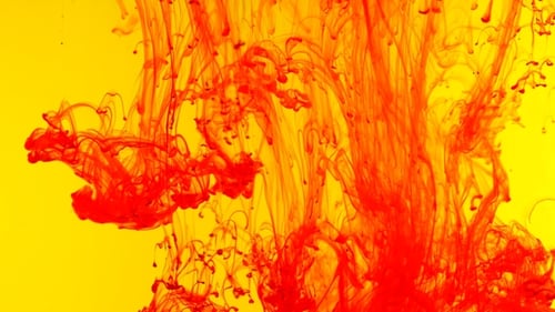 Colour Red Paint on Yellow Reacting in Water Creating Abstract Cloud Formations