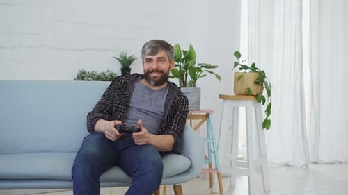 Man With Beard Plays Video Games At Home