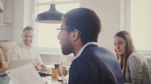 African American Businessman Leading Multiethnic Office Meeting. Young Confident Business People