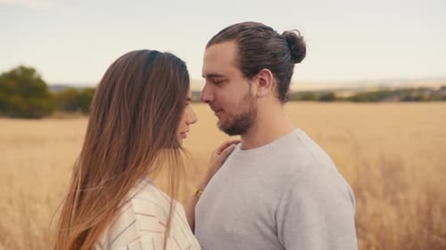 Romantic Couple Standing Face To Face Close To Each Other In The Wheat Field