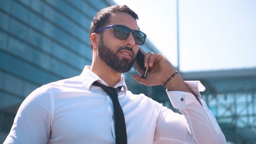 Professional Young Adult on Smartphone Outside Building